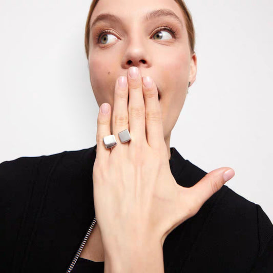 Model wearing silver architectural open ring styled with modern jacket
