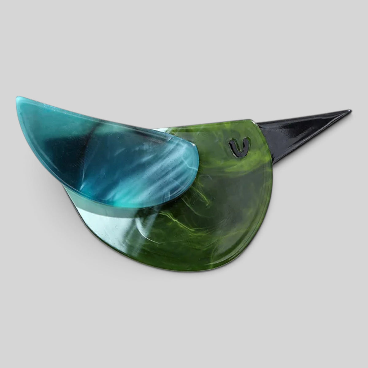 A vintage-style aviator shield with a marbled green and blue acetate lens and a black metal bridge, shown on a neutral gray background.