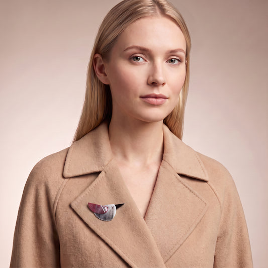 Model wearing colorful acrylic bird brooch on a wool coat collar