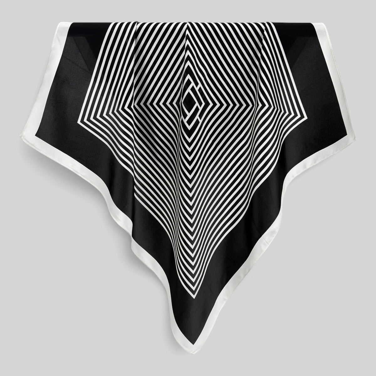 Close-up of rolled edges and high-contrast geometric pattern on pure silk crepe satin