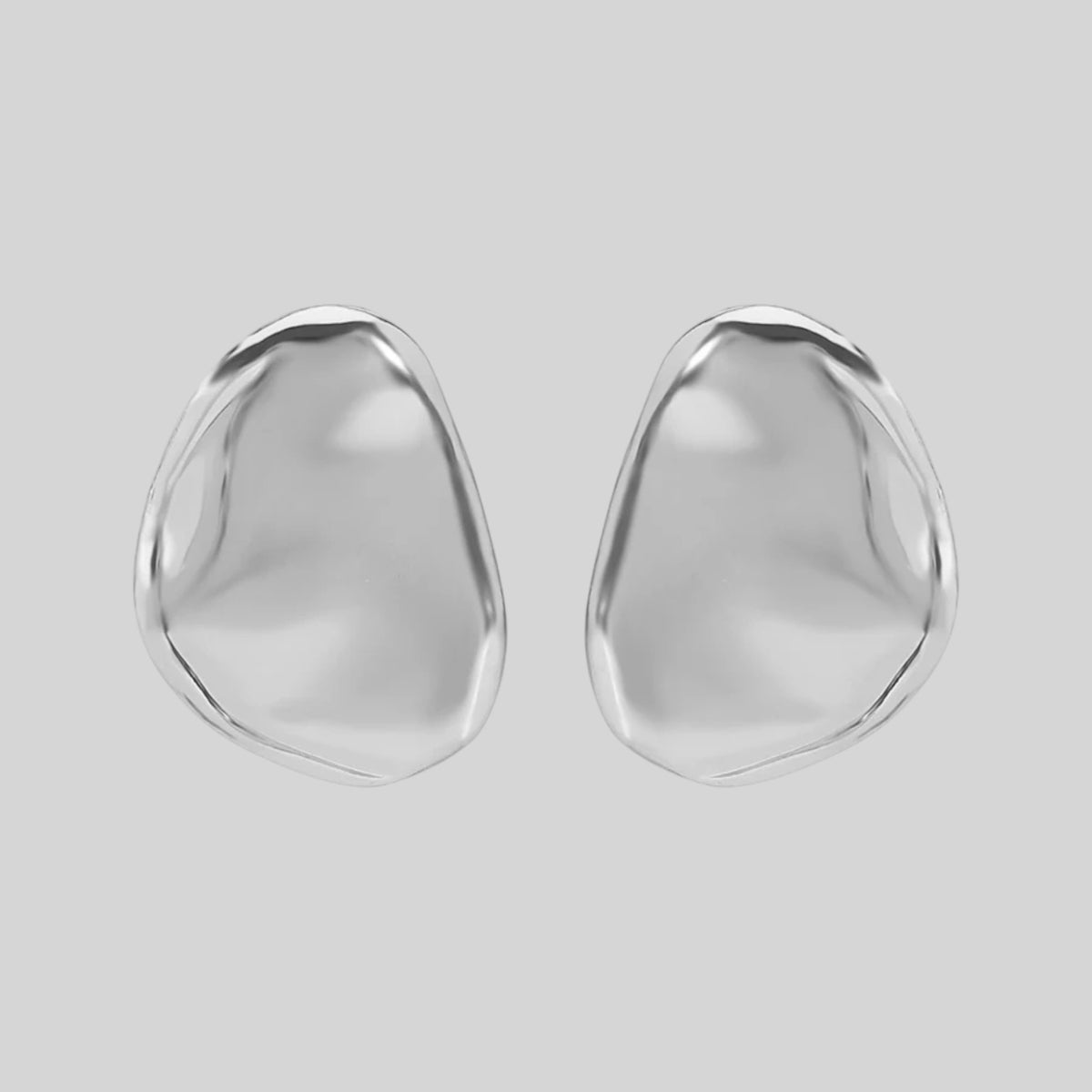 A pair of polished silver stud earrings with organic, fluid teardrop shapes, shown on a solid light gray background.