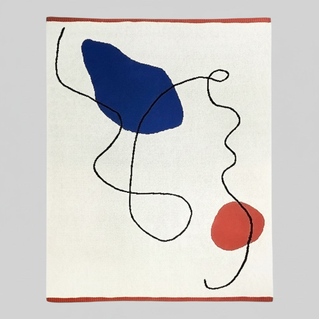Abstract area rug with an off-white textured background, featuring a large navy blue organic shape, a smaller terracotta red circle, and flowing black lines, finished with a terracotta red border.