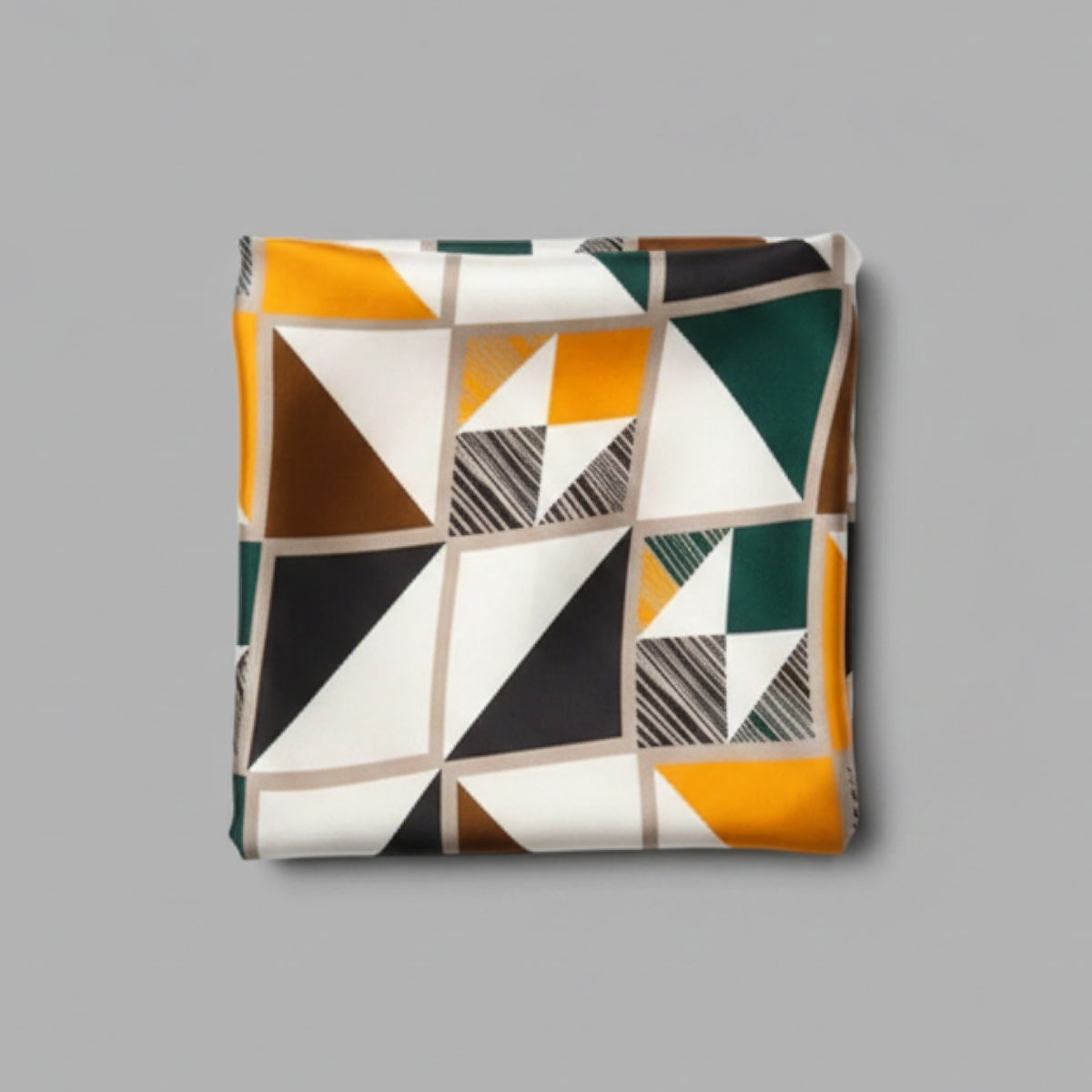 A square throw pillow with a modern geometric pattern of triangles and blocks in mustard yellow, white, black, brown, and dark green, set against a solid gray background.