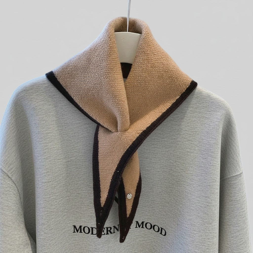 A light gray sweatshirt with a large beige knit collar featuring dark brown trim, displayed on a white hanger against a light gray background. The sweatshirt has 'MODERNIST MOOD' printed in black across the chest.